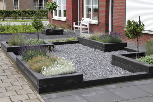 Finished landscape with crushed gravel, raised planters, and ornamental grasses — materials supplied by Cheaper Than Dirt Landscape Supply